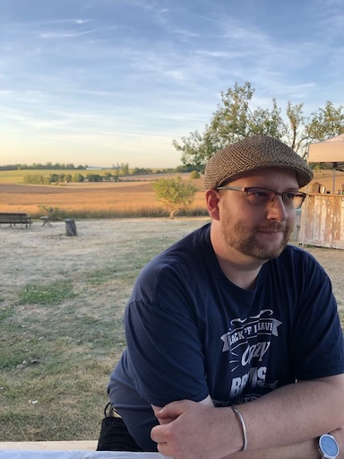 Simon by a fence in a field